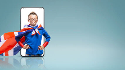 Smiling funny super hero boy posing with arms akimbo  in a smartphone videocall and smiling