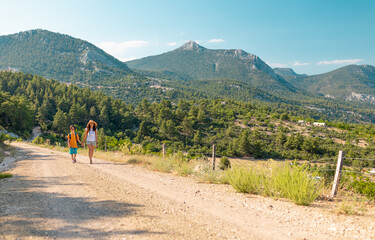 Fototapeta premium The boy with his mother go hiking.