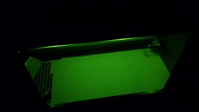 Working 3d printer for metal. 3D printer printing object from metal powder in working chamber by sintering metal powder under laser. SLM. Selective laser melting technology. Melting metal powder