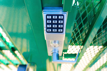Top view of a keypad entry gate lock outdoors