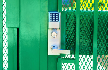 Green fence gate entry lock with keypad, front view