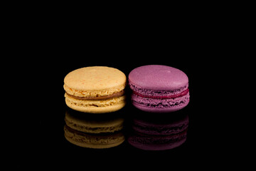 Colorful macaroon over black background