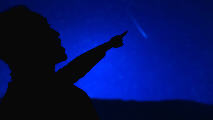 Silhouette of a man with Milky Way starry skies.