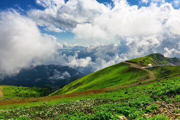 Amazing mountain landscape on sunny summer day with a cloudy sky.