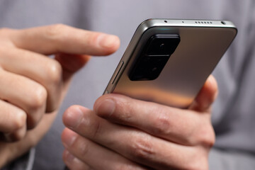 Close up of a man using mobile smart phone