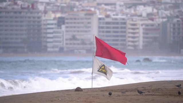 Red flag forbids enter to take a bath at sea, beach seashore seascape. Dangerous, danger sign. 