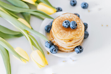 Tasty pancakes with blueberries and honey