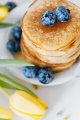 Tasty pancakes with blueberries and honey