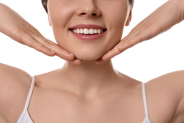 Young woman massaging her face on white background, closeup