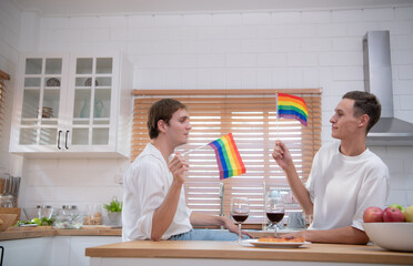 LGBT Young couple celebrate the day of love between each other with fine wine in the kitchen of the house