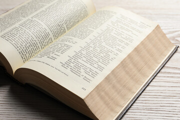 Obraz premium Open Bible on wooden table, closeup. Christian religious book