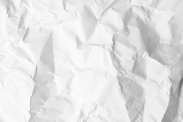 Sheet of crumpled paper white as background, top view