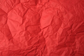 Fototapeta premium Sheet of crumpled red paper as background, top view
