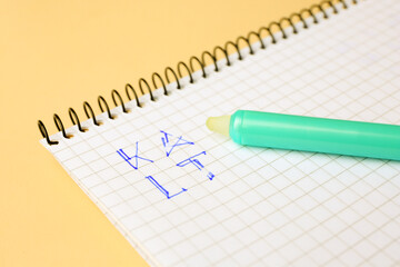 Letters written in notepad with erasable pen on beige background, closeup