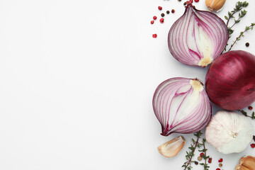 Fresh red onions, garlic, thyme and spices on white background, flat lay. Space for text