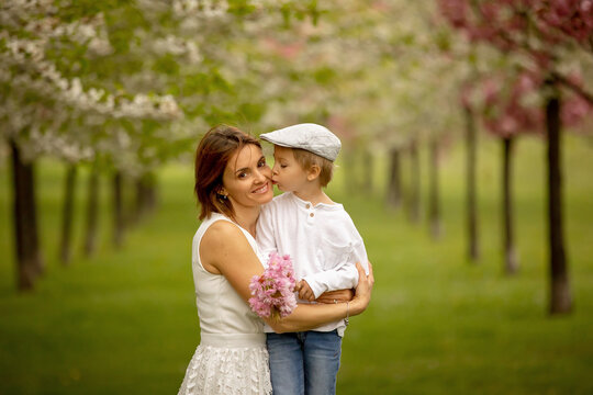 Beautiful family with kids, mom, dad, three boys and a dog, playing in park together