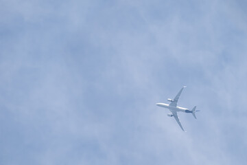 Plane in blue sky with clouds