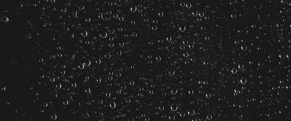 Atmospheric minimal grayscale backdrop with rain droplets on glass. Wet window with rainy drops and...