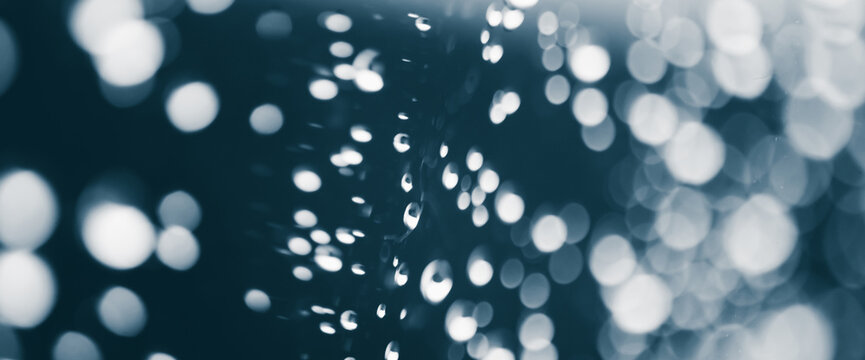 Atmospheric minimal monochrome backdrop with rain droplets on glass. Wet window with rainy drops and dirt spots closeup. Blurry minimalist background of dirty window glass with raindrops close up. - Powered by Adobe