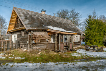 Fototapeta na wymiar Beautiful old traditional wooden house in the village of Margionys, Dzūkija or Dainava region, Lithuania, in winter or spring