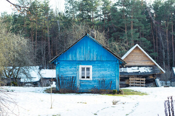 Beautiful old traditional wooden blue house in the village of Margionys, Dzūkija or Dainava region, Lithuania, in winter or spring