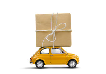 Retro yellow toy car delivering gift box wrapped in kraft paper atop isolated on a white background.