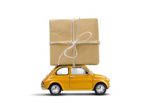 Retro yellow toy car delivering gift box wrapped in kraft paper atop isolated on a white background.