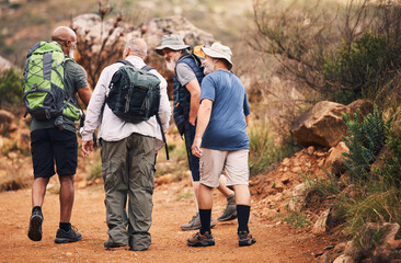 Hiking, travel and walk with old men on mountain for fitness, trekking and backpacking adventure. Explorer, discovery and group with elderly friends in nature for health, retirement and journey