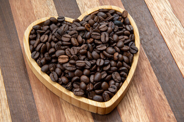 coffee beans in heart-shaped tra,y representing love of coffee