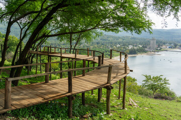 Fototapeta na wymiar Old wooden bridge on the hill with seascape view. wooden bridge with beautiful view at Aceh Besar, Indonesia