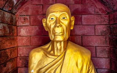 Bronze Buddha statue in a temple in Mae Sot Thailand