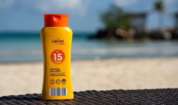 Aldi Lacura Sun SPF15 yellow bottle of sun lotion in a Caribbean beach setting, Falmouth, Jamaica, 16 December 2022	

