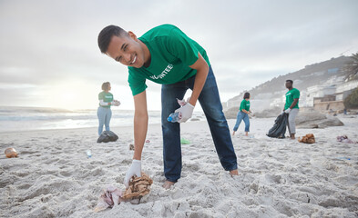 Volunteer portrait, beach cleaning or man for recycling plastic bottle for community service, pollution and earth day. Smile, ngo team or sand trash for climate change, nature and helping environment - obrazy, fototapety, plakaty