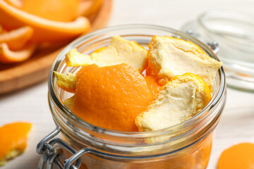 Orange peels preparing for drying on white wooden table, closeup