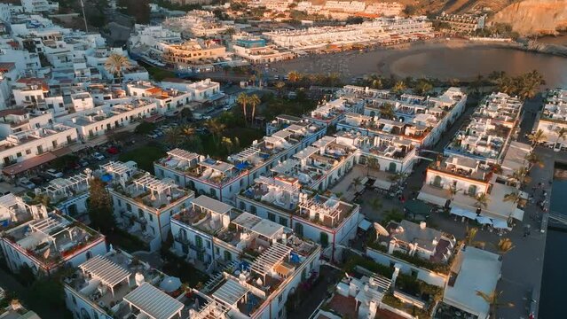 Puerto de Mogan fishing town aerial view at sunset. Traditional colorful buildings with many fishing boats at Gran Canaria, Canary Islands, Spain