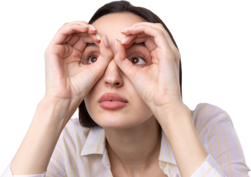 Close up portrait of attractive quirky young woman making binoculars with hands showing ok gesture on white studio background.