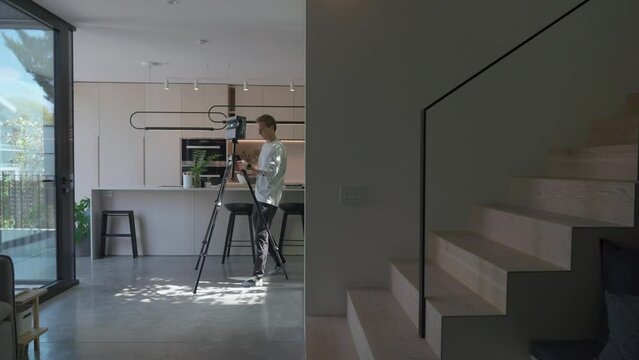 Close up of floor planner walks slowly holding tripod with matterport device mounted through modern home finding a new spot to place the device for the next scan.
