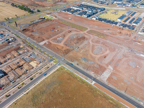 Aerial view of cleared land blocks in an urban subdivision