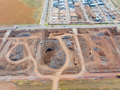 Aerial view of cleared land blocks in an urban subdivision