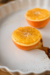 halves of baked oranges with cinnamon