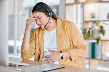 Call center, headache and pregnancy, woman at desk with hand on stomach, exhausted in office with headset. Burnout, pain and pregnant telemarketing consultant with anxiety from deadline time stress.