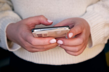 Woman's hands holding a mobile phone close-up