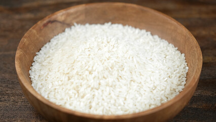 Fototapeta na wymiar Paw rice in wooden bowl, close up