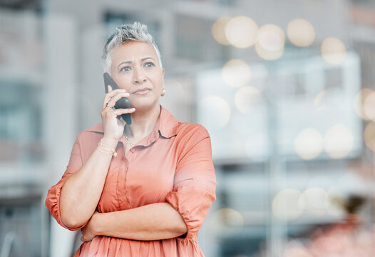 Sad, phone call and senior business woman talking, chatting or speaking in workplace. Bokeh window, cellphone communication and ceo thinking, angry and bad news discussion on smartphone.