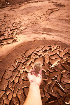 Outback riverbed dusty dirt in the palm of hand