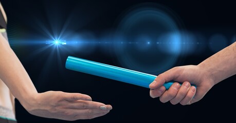 Composition of caucasian athletes passing green relay baton over black background