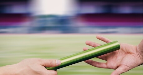 Composition of midsection of caucasian athletes passing green relay baton