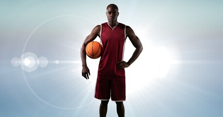 Fototapeta premium Composition of male basketball player holding basketball with copy space
