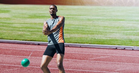 African american male athlete hammer throwing against sports field in background