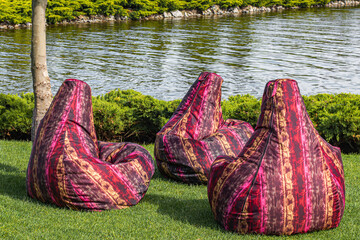 Multicolor bean bag chairs on lawn with view on river
